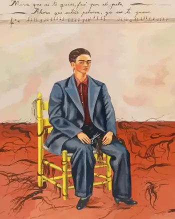 Frida Kahlo in a blue suit seated among strands of cut hair